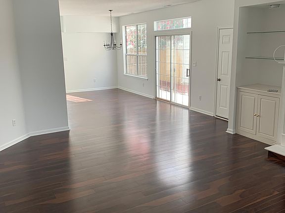 Living room in the front and dining room towards the back. View when you walk in front door.