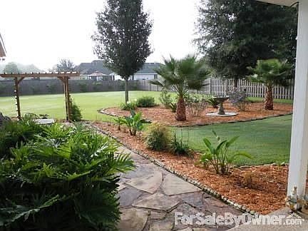 Landscaped View Off Of Back Porch : Lot Size 110 ft X 243 ft X 110 ft X 251 ft