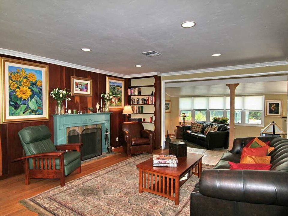Classic fireplace, gleaming hardwood floors, spacious living area