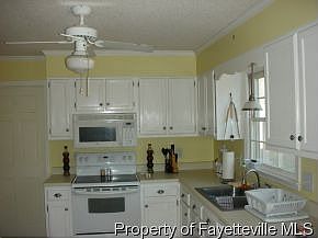 Bright airy kitchen with view of large backyard