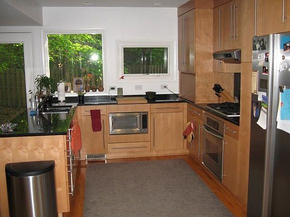 Kitchen with stainless applainces, granite  countertops, and hardwood floors. 