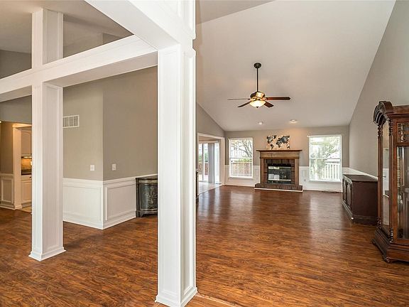 View front he front door of part of the dining room and the Great Room. Great Room is vaulted with gas fireplace and judges panel.