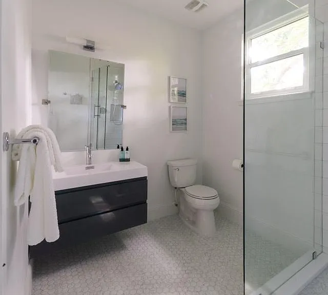 En-suite master bath with large walk in shower and marble mosaic tile floor