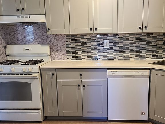 New remodeled kitchen with stone countertop and modern style cabinets