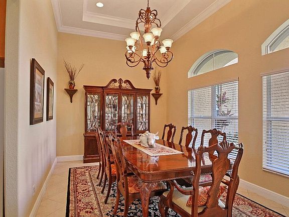 THIS ELEGANT DINING ROOM IS FULL OF LIGHT FROM THE COURTYARD WINDOWS AND FOUNTAIN.