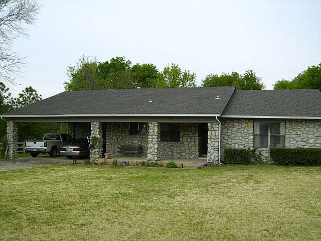 Front, Full Rock and Brick W/vinyl over all wood, new Roof in 2000