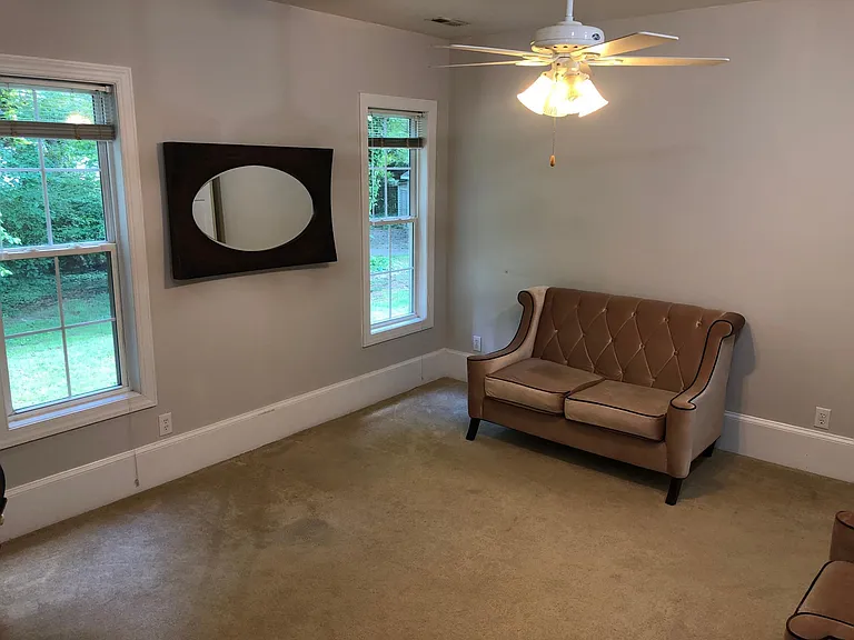 First guest bedroom, located directly behind dining area. Windows overlook backyard