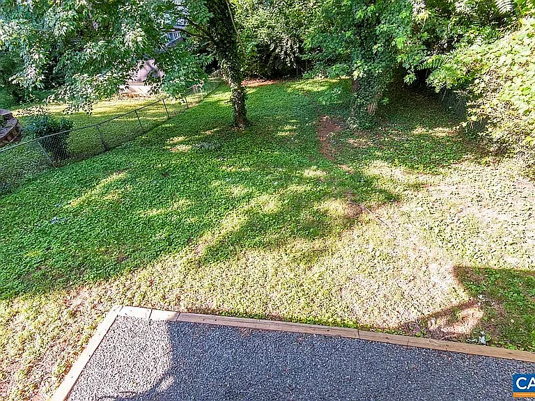 View of fenced in yard from upper patio
