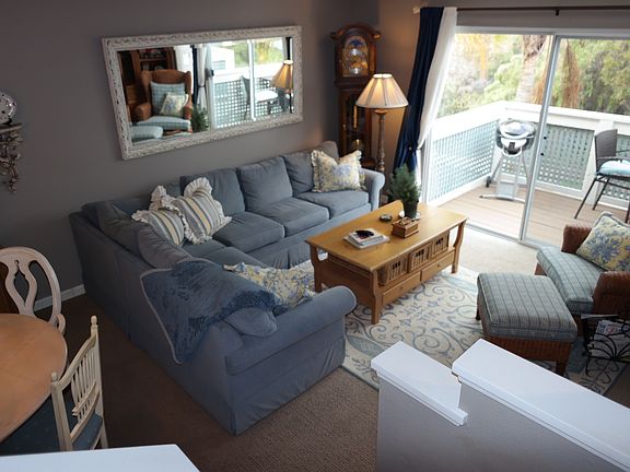 Living/Dining area and balcony facing open outdoor spaces