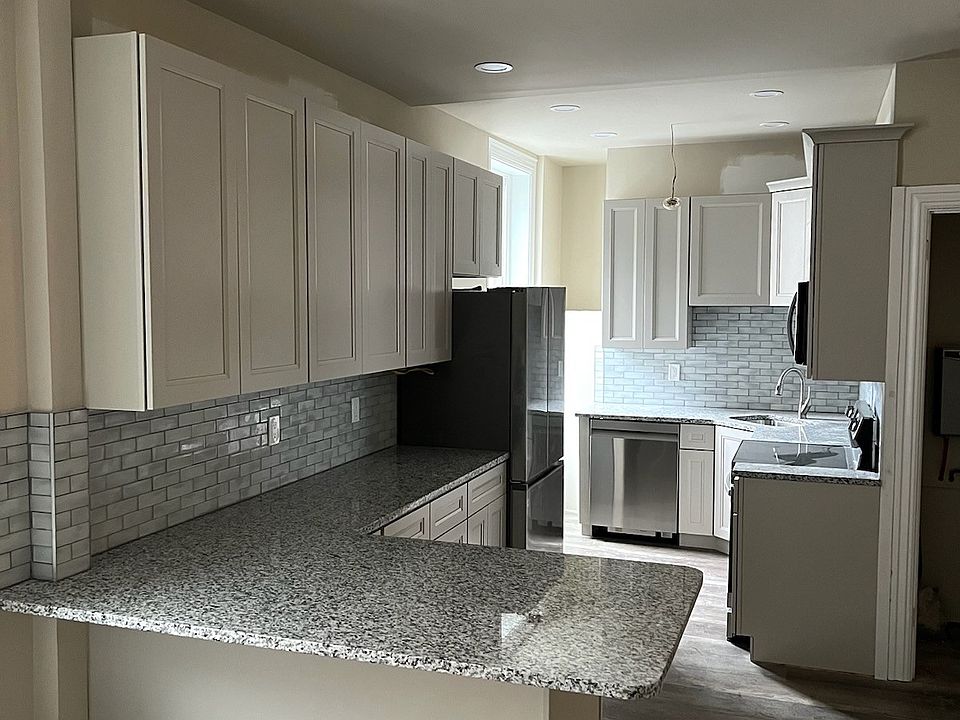 Kitchen-custom cabinets with under counter lighting up granite countertops, lots of storage including pull outs and lazy susan
