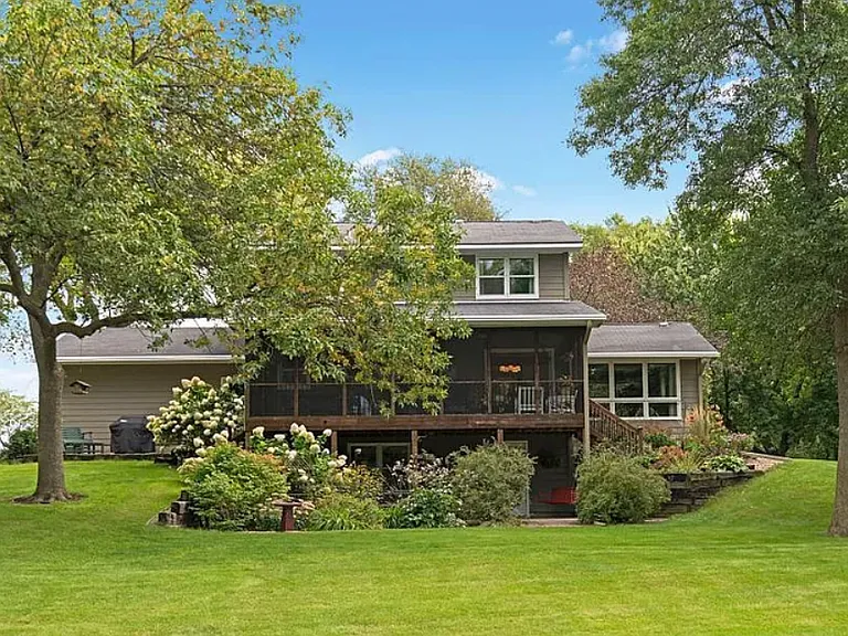 Back of house and 3-season screened porch and lower level walk-out patio