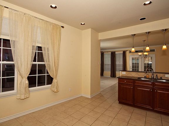 Open layout with eat-in kitchen and dining area.
