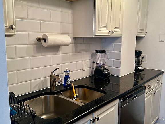 Classy set up with white subway tile and sleek easy to keep looking nice black granite.