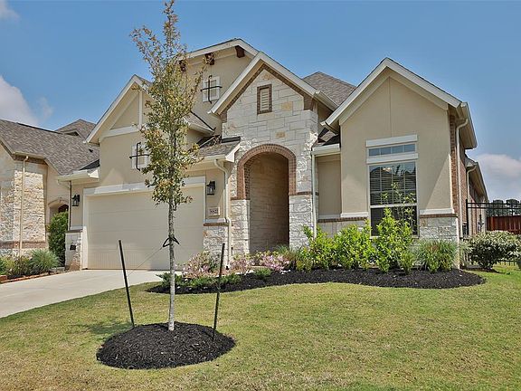 Lovely stucco, stone and brick elevation.