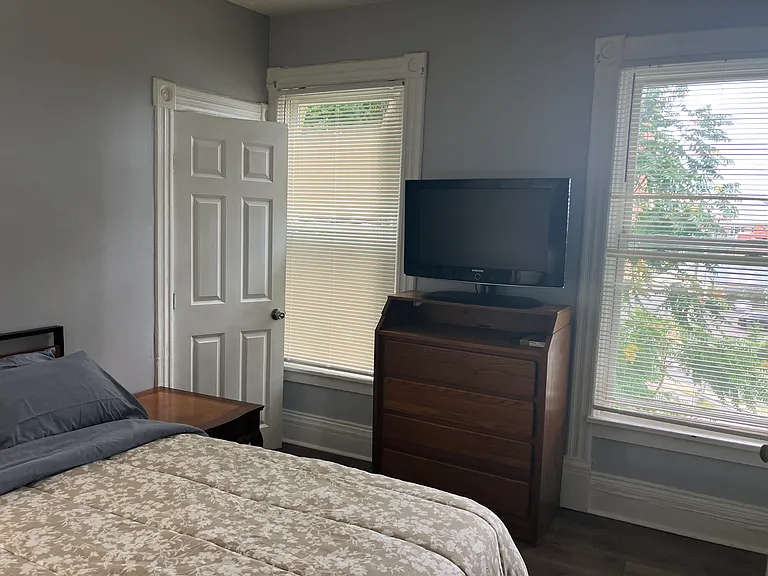 Bedroom 2 with dresser and TV