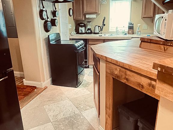 Well-stocked kitchen - includes many small appliances, dishwasher, oven, microwave, pots/pans, dishes, utensils, ready to move in!