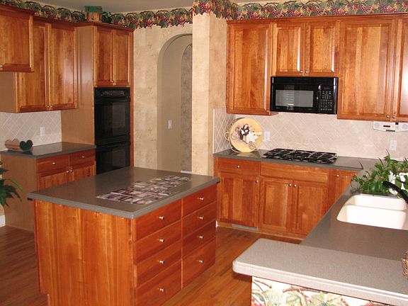 Great kitchen with double ovens, built-in microwave, gas cooktop, and island