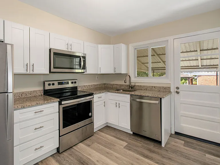 Beautifully updated kitchen with stainless appliances, granite countertops, & brushed nickel accents.