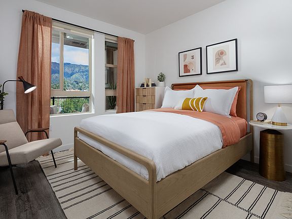 model bedroom with a bed and a chair