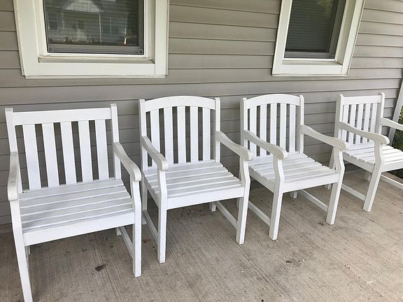 Front porch includes 4 wooden chairs for relaxing