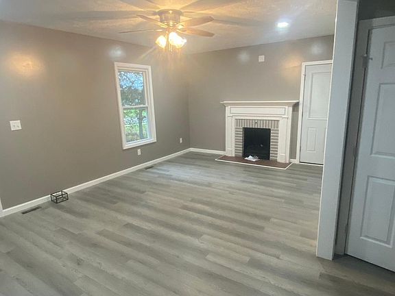 Living room has been remodeled to include new lighting and fireplace.