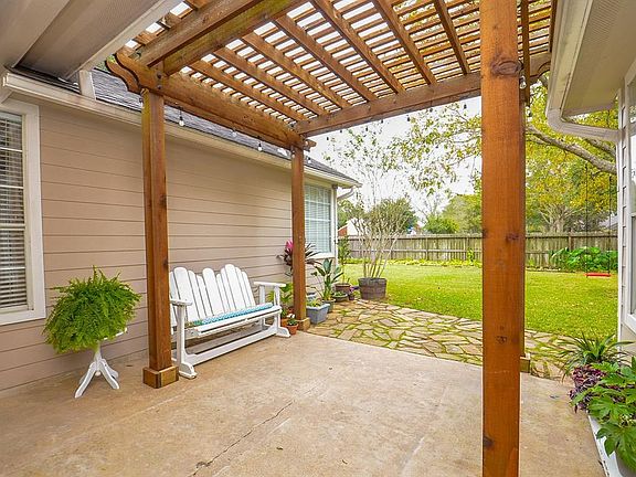 Pergola covered patio with accent lighting overlooks the private, sprawling back yard with NO BACK NEIGHBORS!