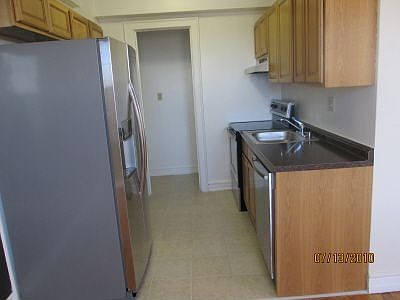 Stainless steel appliances and tile flooring.