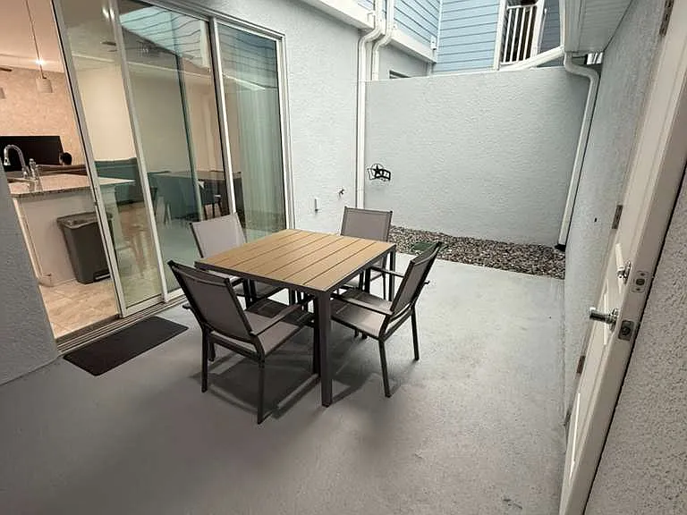 Relaxing patio with table and four chairs.