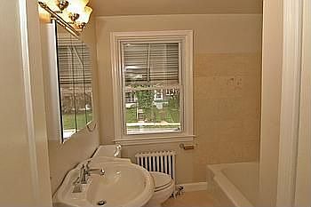 Totally Updated Master Bathroom with Ceramic Tile and Pedestal Sink