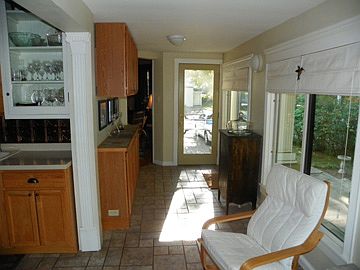 more kitchen cabinets and an entry from the driveway