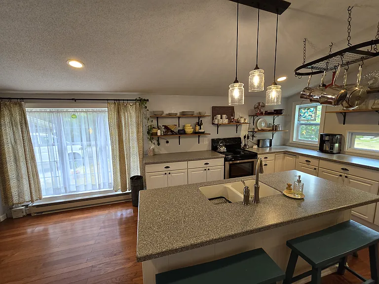 Maximum storage and conveniences. Kitchen cabinets complete with roll-out trays, pull-out trash, and lazy susan. Also has newer dishwasher with third rack, and double sink has garbage disposal.
