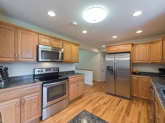 This kitchen is a cook's dream with stainless appliances, cupboard space galore, and expansive countertops.  New recessed and pendent lighting adds the finishing touch to this great space.