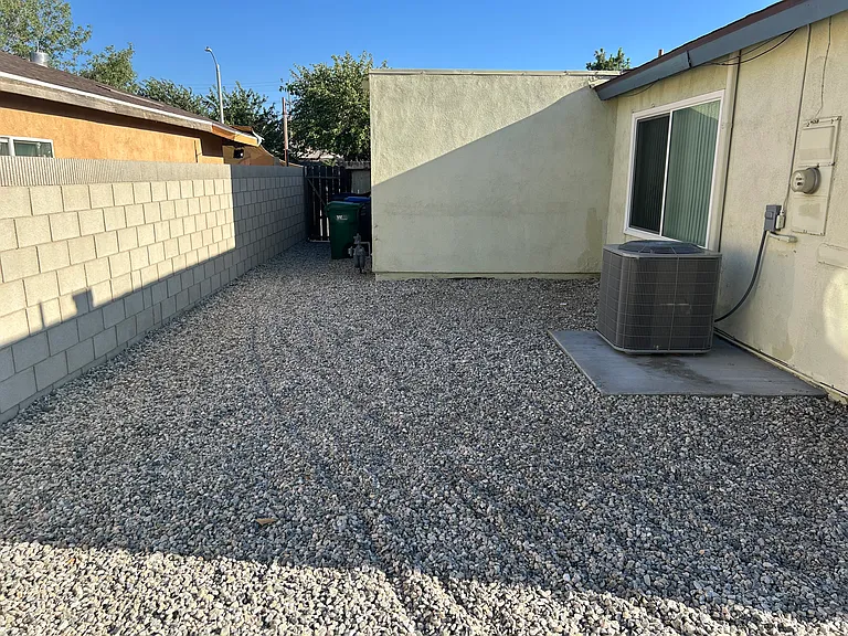 EAST SIDE BACK YARD HAS ROCKS