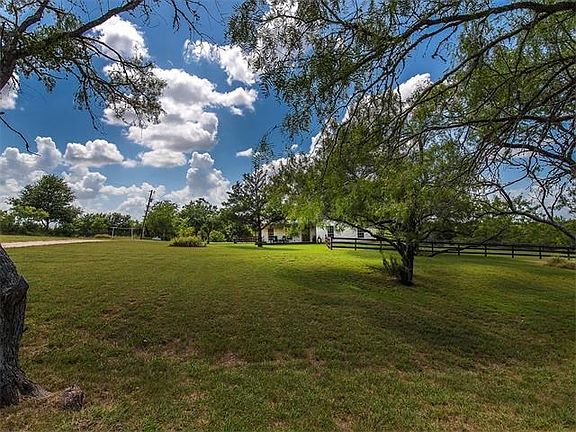 The front yards mature trees create plenty of shade and the  fenced area gives children and your pets a place to play.