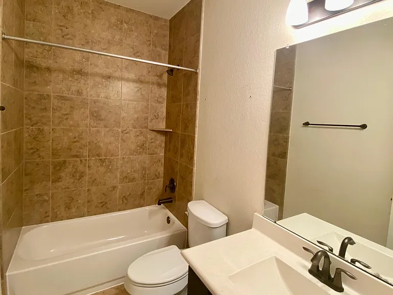 Second bathroom with nice tiling and fixtures