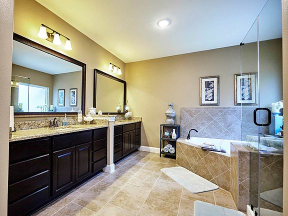 Master bath complete with a large corner tub