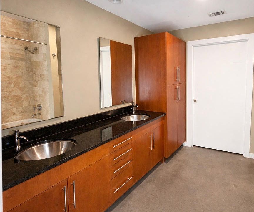 bathroom with granite double sink