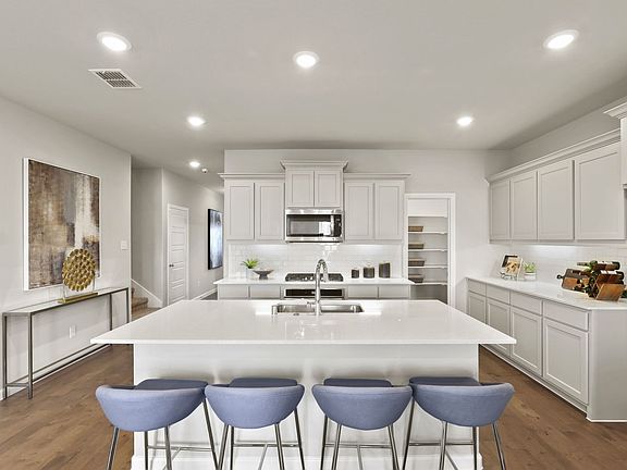 Kitchen in the Masters home plan by Trophy Signature Homes - REPRESENTATIVE PHOTO