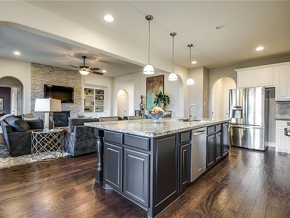 How pretty is this!?  View of the open kitchen to the family room.  Notice how open and light and bright it is!