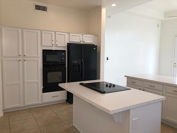 Kitchen with refrigerator, Microwave and oven combo.