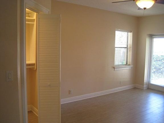 Master bedroom has view of the lake, a door to the patio and a walk-in closet with California Closet shelving.