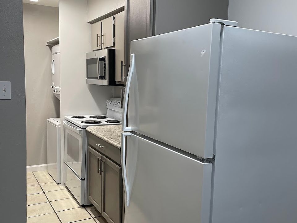 Kitchen includes a full-sized stackable washer/dryer, microwave and large pantry.