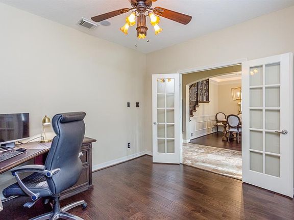 Spacious study with glass french doors, and new rich hard wood flooring makes for a great home office, den or play room for kids.