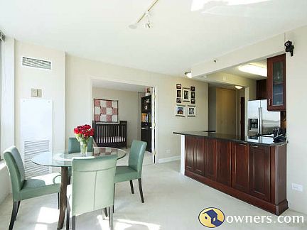 Shot of dining area + kitchen + french doors into 2nd bedroom
