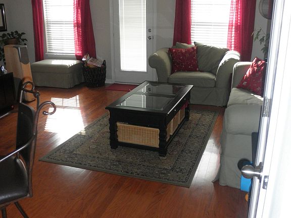 Living Room w/ hardwood floors and crown moulding .