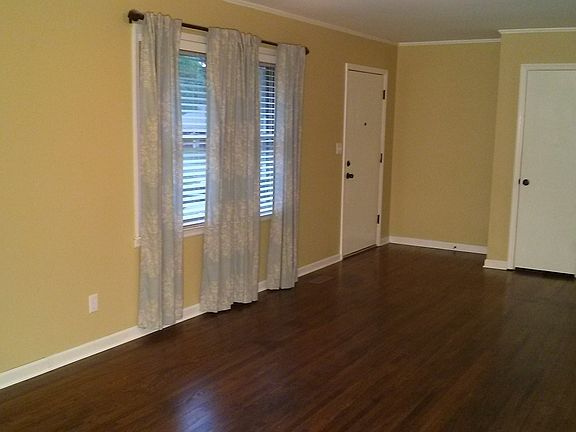 Large living room boasts beautiful refinished wood floors