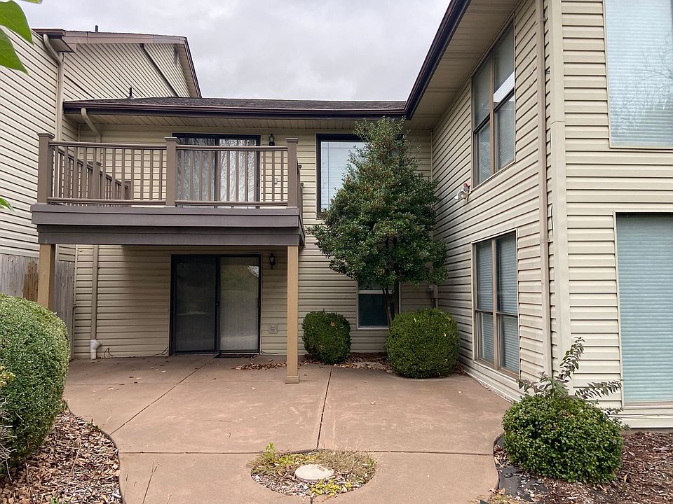Rear view, upper level balcony and lower level patio