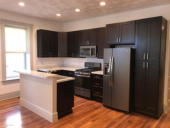Kitchen: all stainless steel appliances: ample counter space, island with bar seating