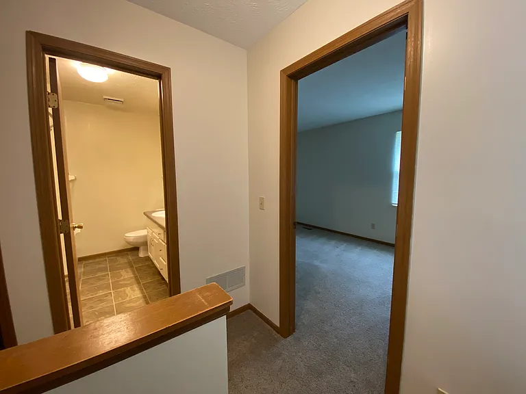 Second story hall view into bathroom and master bedroom