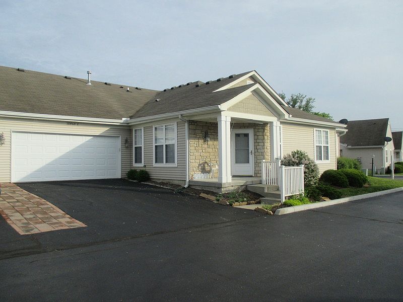 Entry with 2 car garage
						:
						entry to one level condo showing attached garage